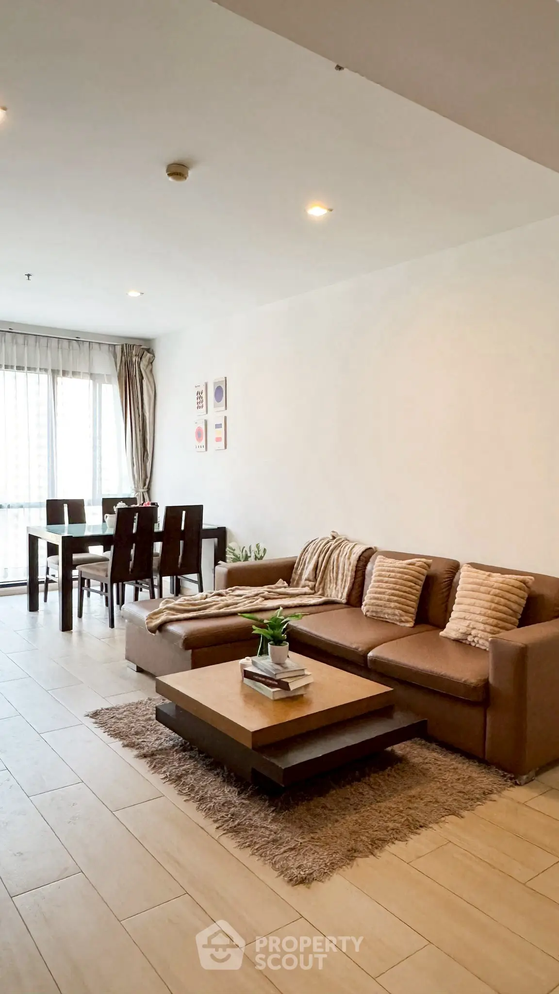 Spacious living room with modern furniture and dining area, perfect for entertaining.