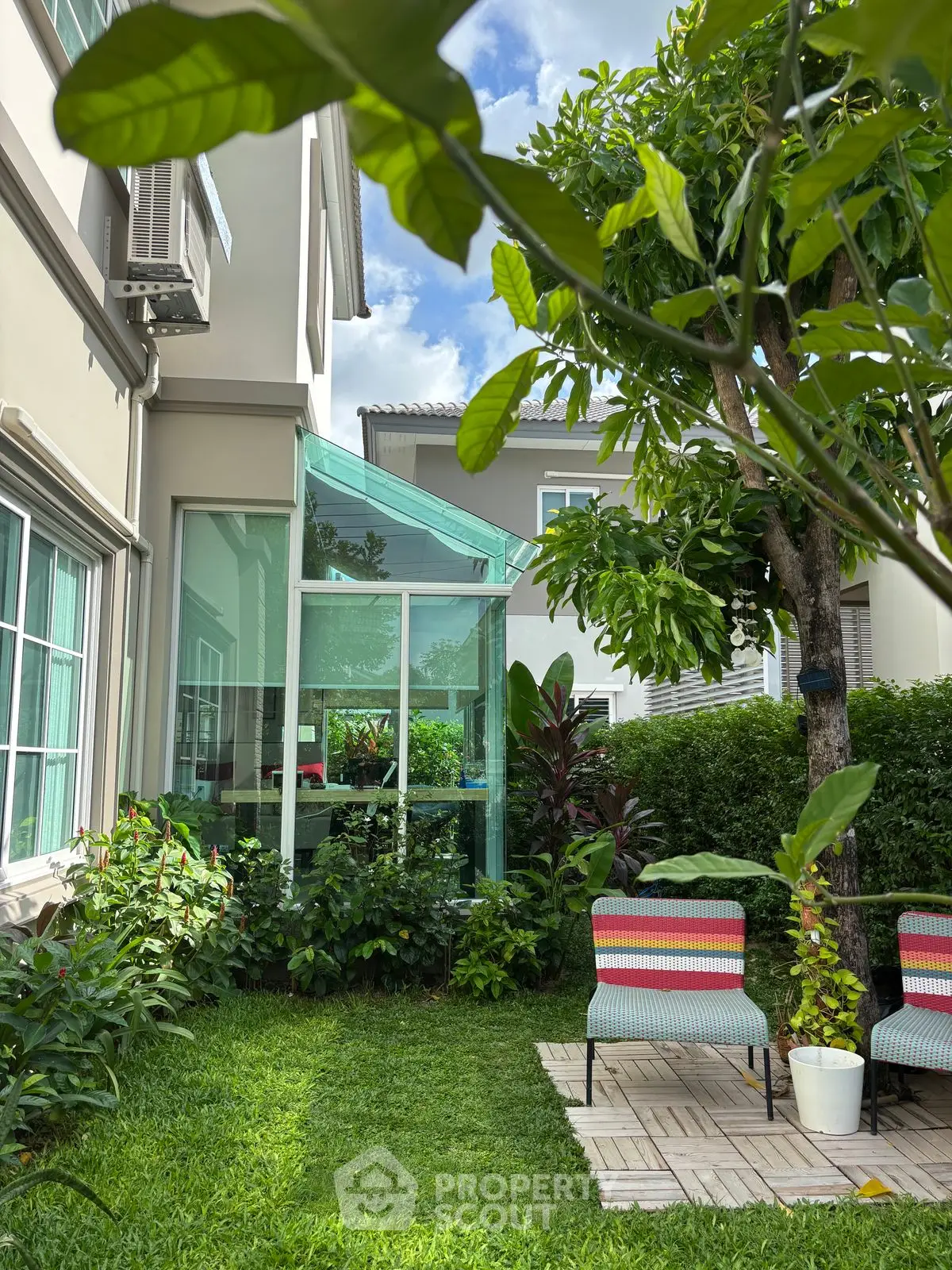 Charming garden with patio seating and lush greenery in a modern residential property.