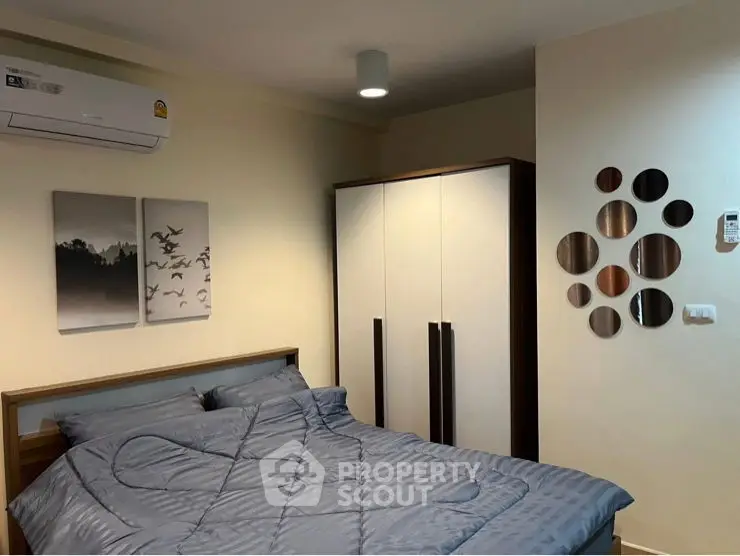 Modern bedroom with stylish wall decor and cozy bedding