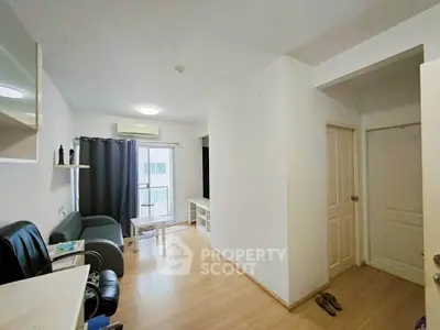 Spacious living room with modern decor and natural light, perfect for relaxation and entertainment.