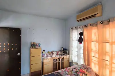 Cozy bedroom with air conditioning and natural light, perfect for relaxation and comfort.