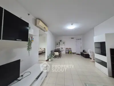 Spacious living room with modern furniture and air conditioning in a bright apartment.