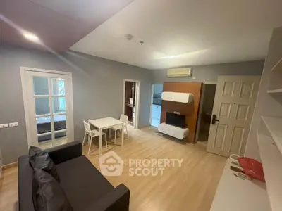 Modern living room with open layout, stylish furniture, and wooden flooring in a cozy apartment.