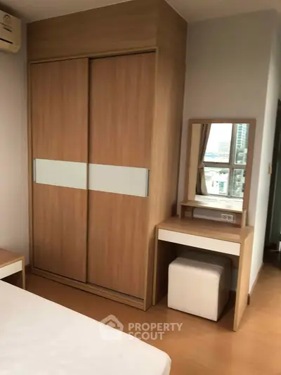 Modern bedroom with sleek wooden wardrobe and stylish vanity set