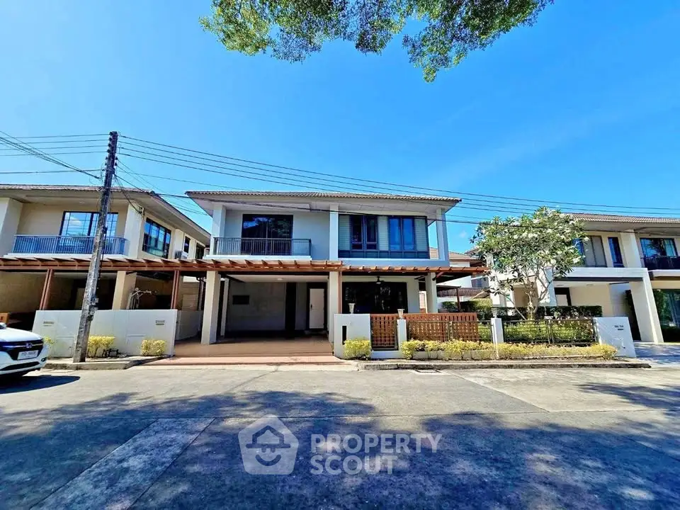 Modern two-story house with spacious driveway and landscaped front yard in a suburban neighborhood.