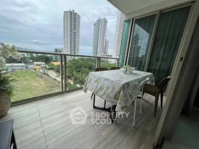 Spacious balcony with city view, perfect for outdoor dining and relaxation.