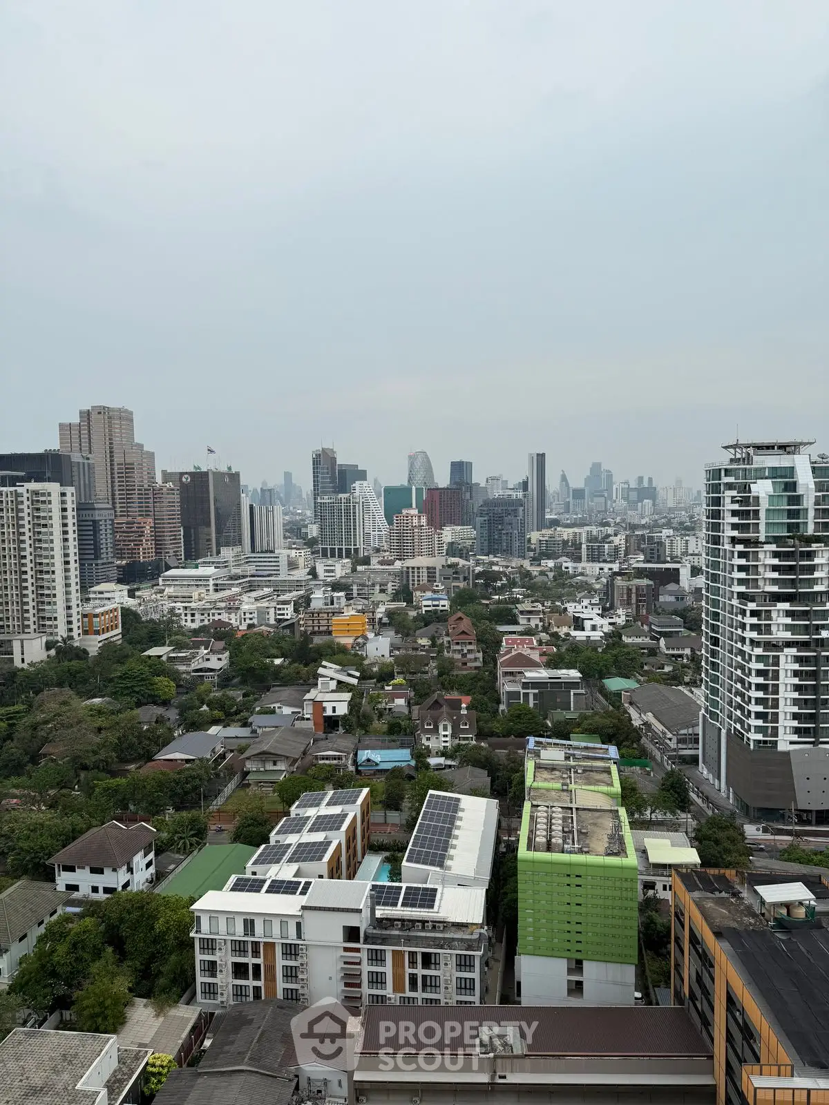 Stunning cityscape view from high-rise building showcasing urban skyline and residential area.