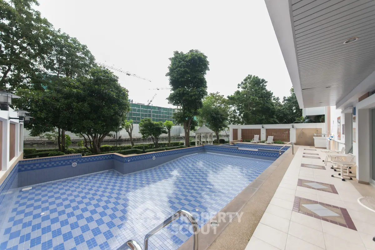 Luxurious outdoor swimming pool with modern design and lush greenery, perfect for relaxation and leisure.
