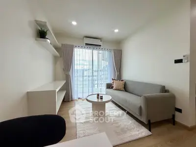 Modern living room with stylish sofa, elegant curtains, and natural light from large window.