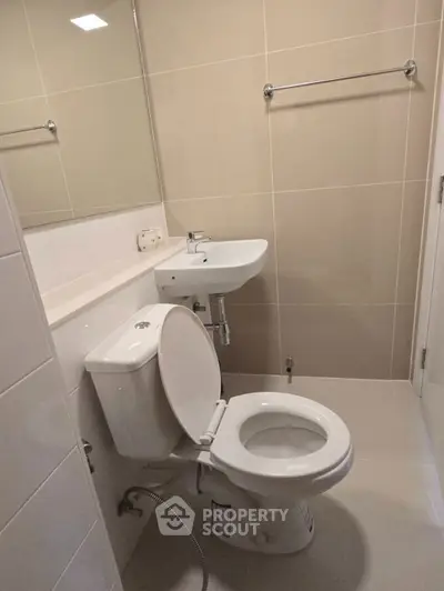 Modern bathroom with sleek fixtures and neutral tiles