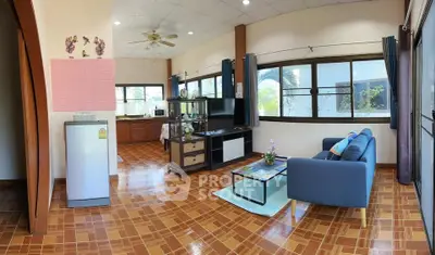Spacious living room with modern decor and large windows for natural light
