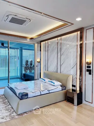 Luxurious bedroom with modern design, featuring a stylish bed and elegant marble wall accents.
