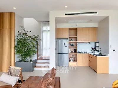 Modern open-layout kitchen with sleek appliances and stylish decor
