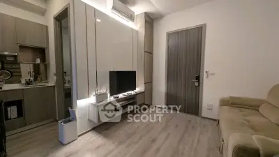 Modern living room with sleek design and integrated kitchen area