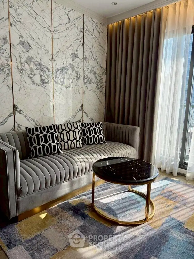 Luxurious living room with elegant marble wall and plush sofa, perfect for sophisticated urban living.