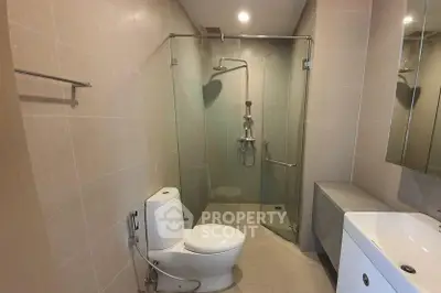 Modern bathroom with glass shower enclosure and sleek fixtures