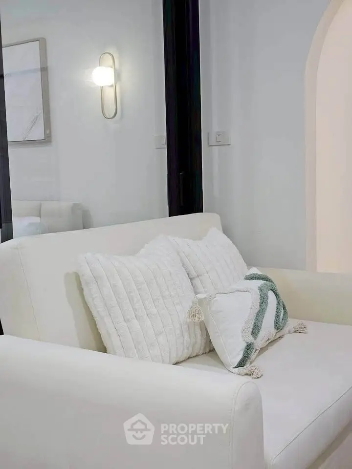 Modern living room with elegant white sofa and stylish decor