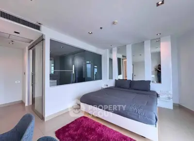 Modern bedroom with glass partition and stylish decor