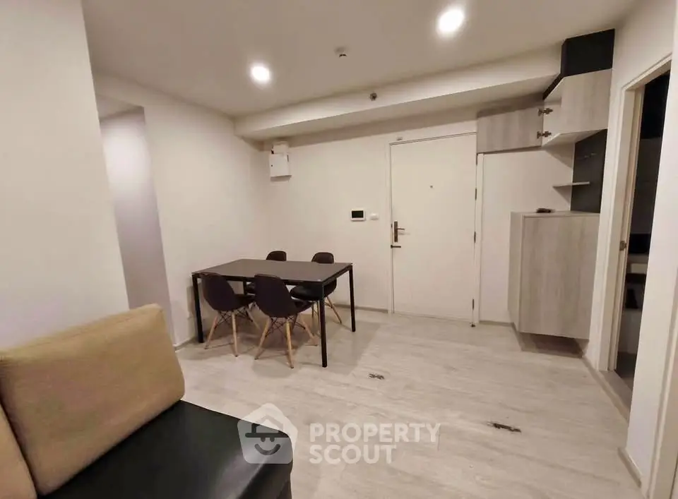 Modern minimalist living room with dining area and sleek furniture