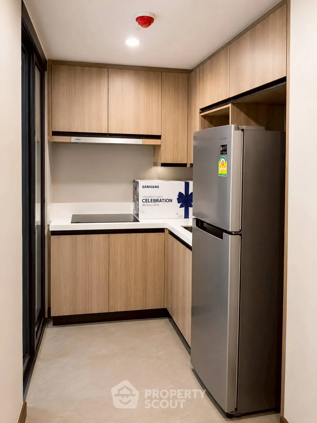 Modern kitchen with sleek cabinetry and stainless steel appliances in a compact layout.