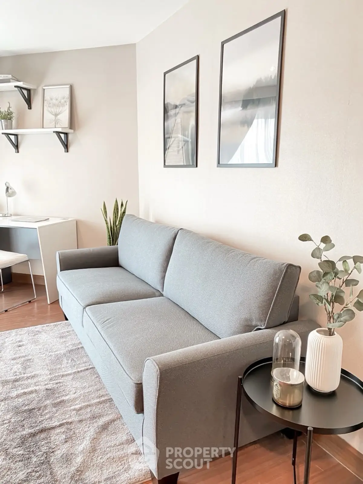 Modern living room with stylish gray sofa, elegant decor, and cozy ambiance.