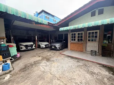 Spacious residential property with ample parking space and covered carport.