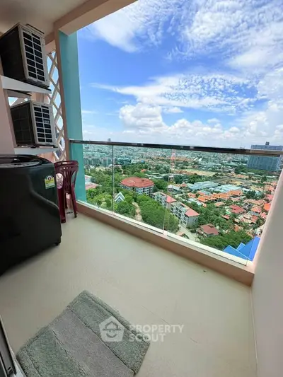 Stunning high-rise balcony with panoramic city views and modern glass railing.