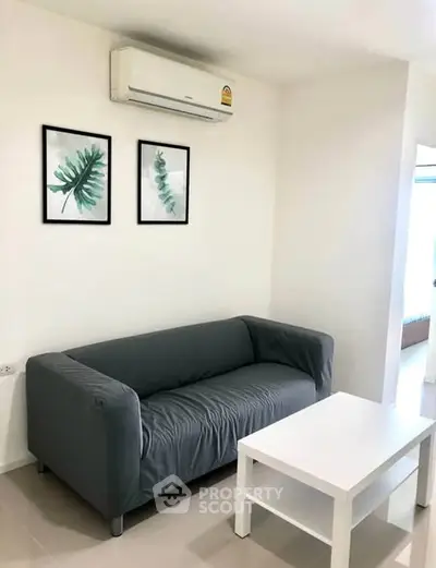 Modern living room with sleek gray sofa and minimalist decor