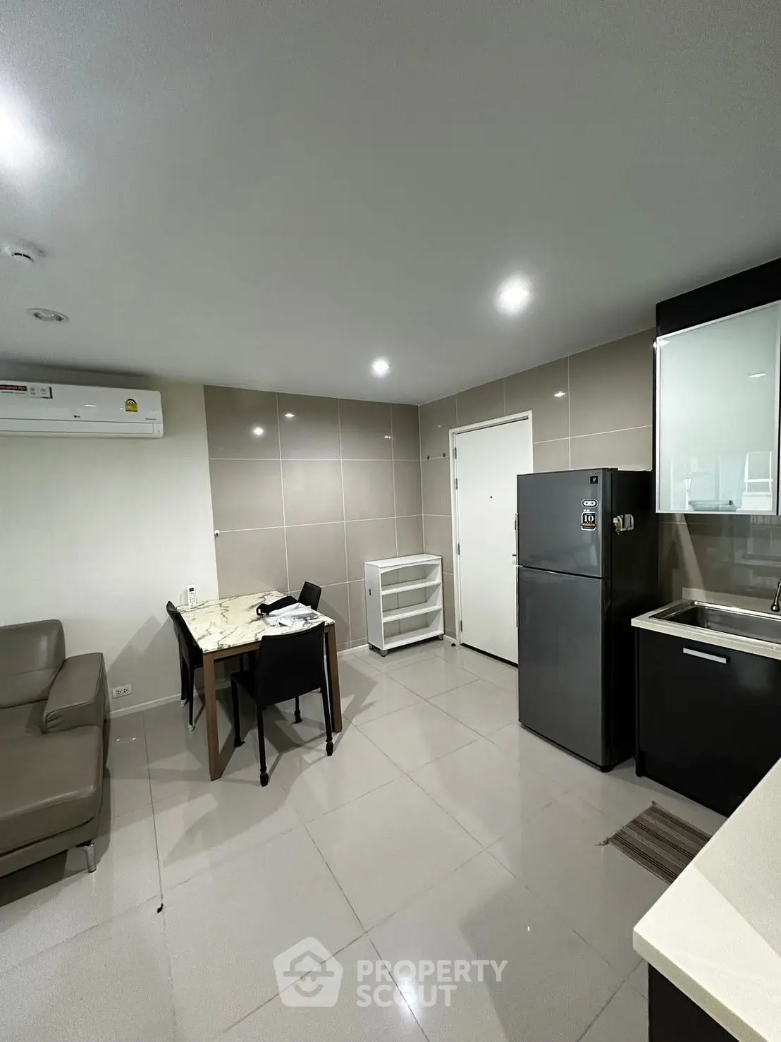 Modern kitchen and dining area with sleek appliances and stylish furniture