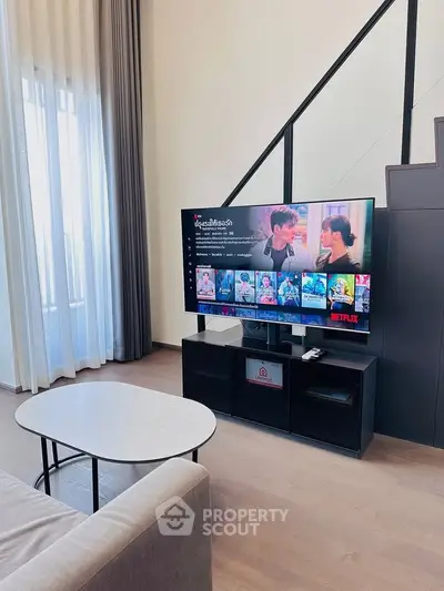 Modern living room with sleek TV setup and natural light