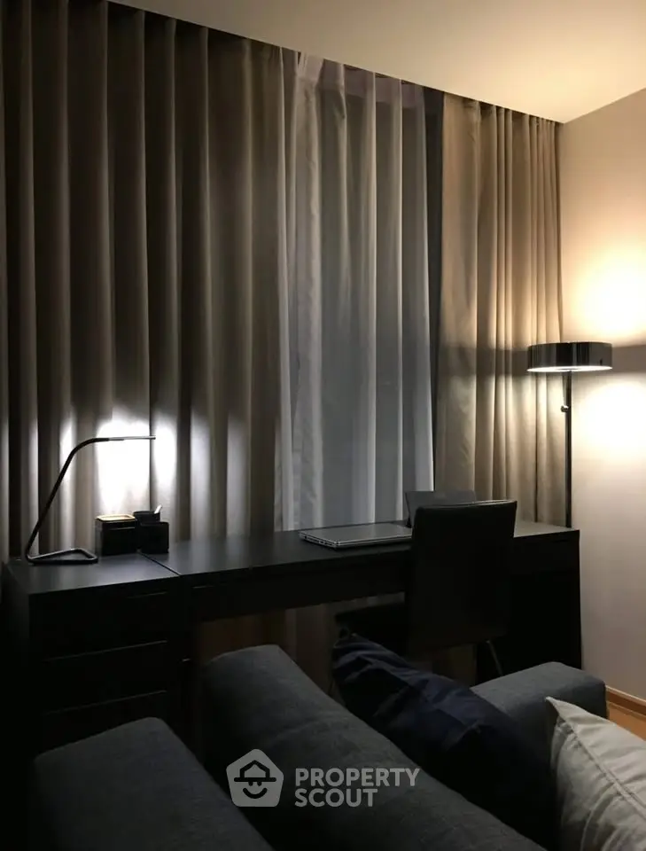 Elegant study area with modern desk and ambient lighting in a cozy apartment.