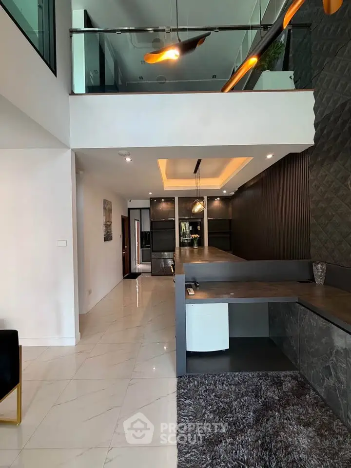 Modern interior with mezzanine, sleek design, and stylish lighting in a contemporary home.