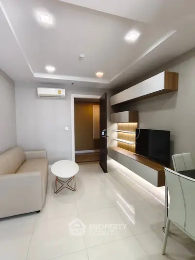 Modern living room with sleek furniture and built-in TV unit, perfect for urban living.