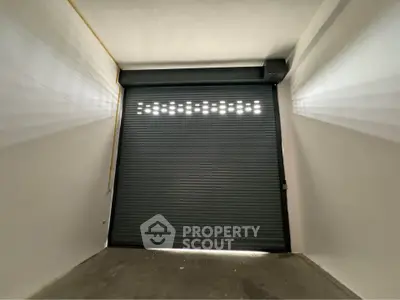 Spacious garage with secure roller door in modern building