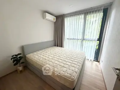 Spacious bedroom with large window and modern air conditioning unit