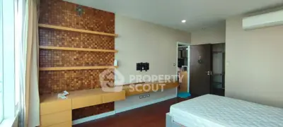 Modern bedroom with wooden accents and built-in storage solutions