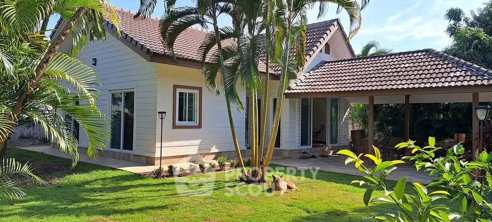 Charming tropical home with lush garden and spacious patio, perfect for outdoor living.