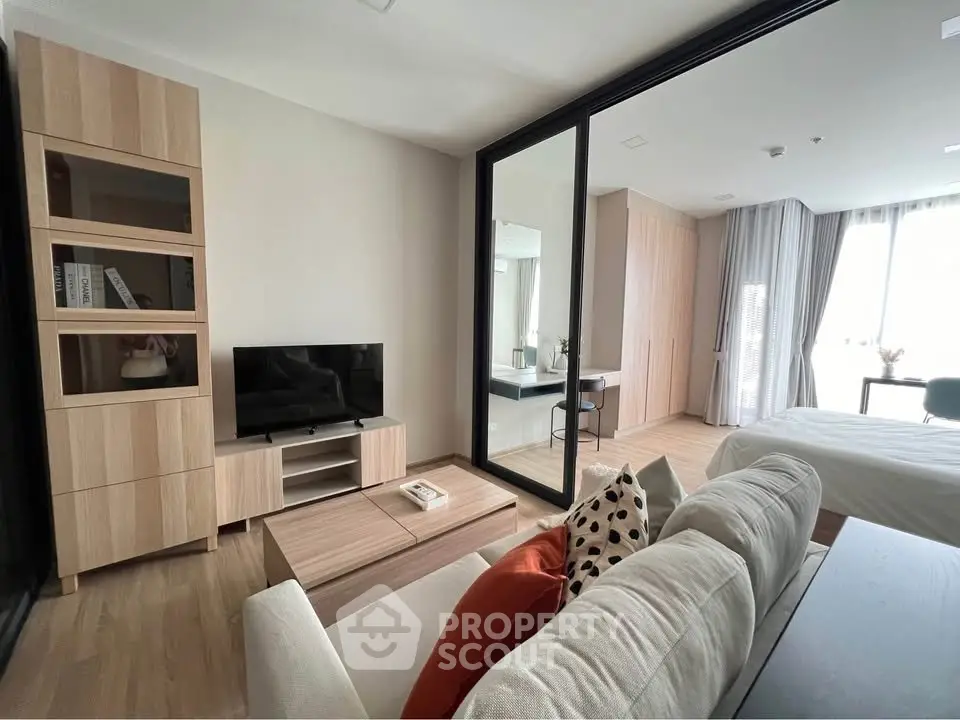 Modern living room with sleek furniture and large windows in a stylish apartment.
