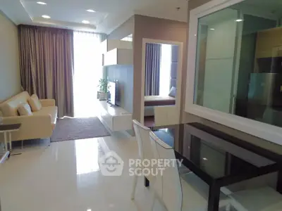 Modern living room with sleek furniture and large window, perfect for urban living.