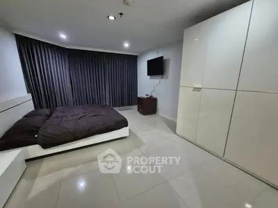 Spacious modern bedroom with sleek design and ample storage