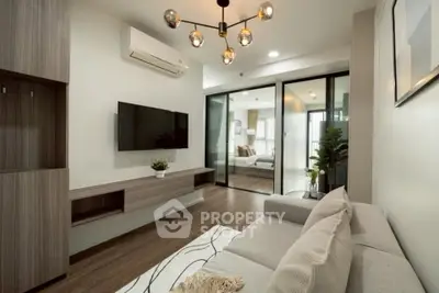 Modern living room with sleek design and open layout, featuring a cozy sofa and stylish lighting.
