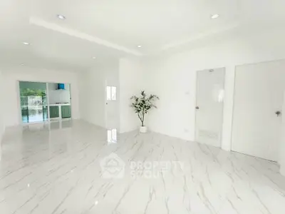 Spacious modern living room with elegant marble flooring and bright natural light.