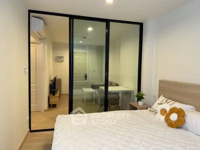 Modern bedroom with glass partition and cozy decor