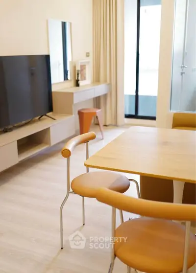 Modern living room with stylish furniture and large TV, perfect for relaxation and entertainment.