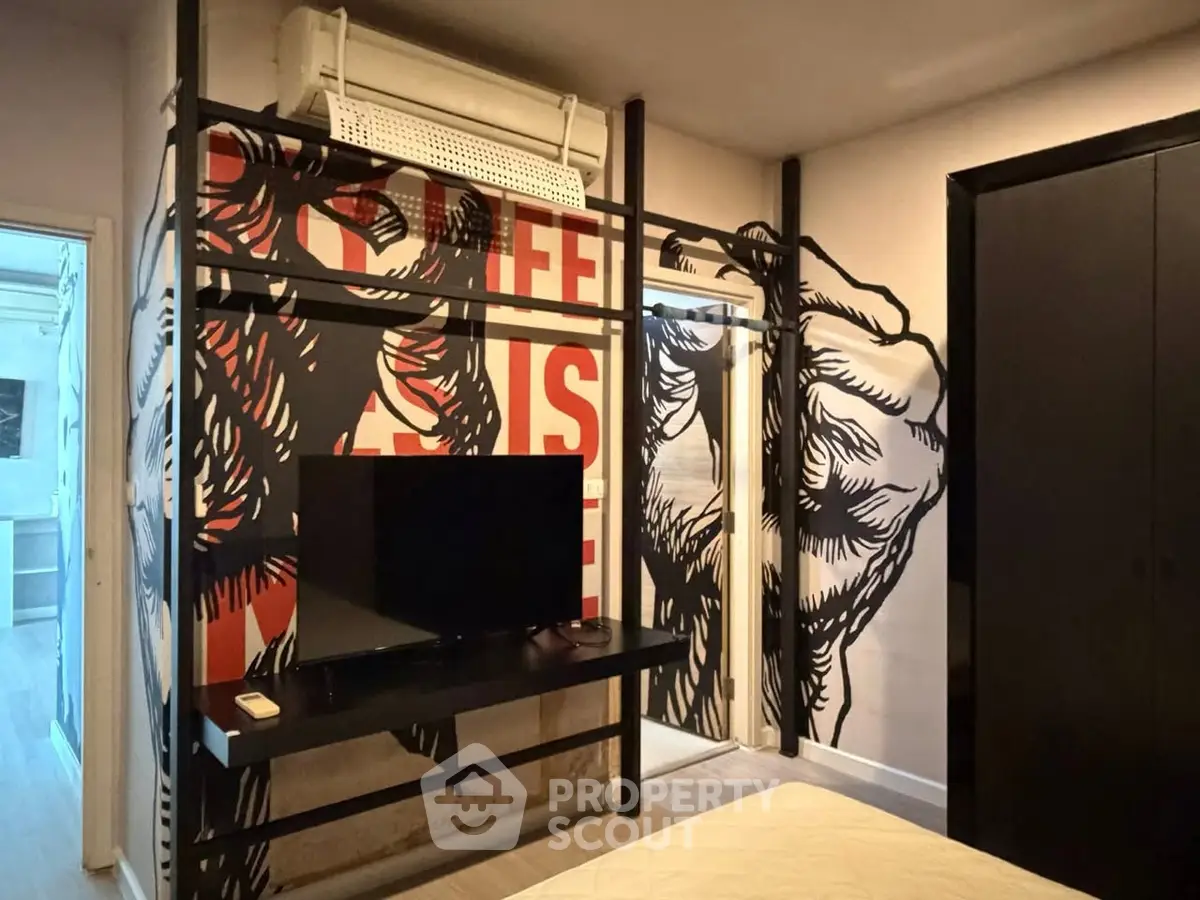 Stylish bedroom with unique wall art and modern TV setup