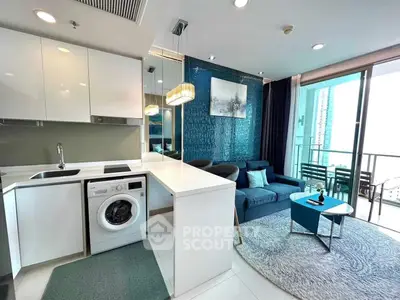 Modern open-plan living room with kitchen, featuring stylish decor and balcony access.