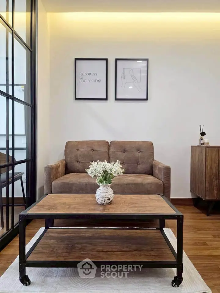 Chic living room with stylish sofa and industrial coffee table, perfect for modern urban living.