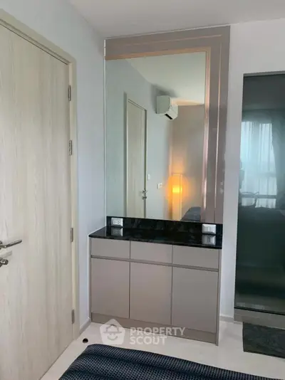 Modern bedroom corner with sleek mirror and stylish cabinet