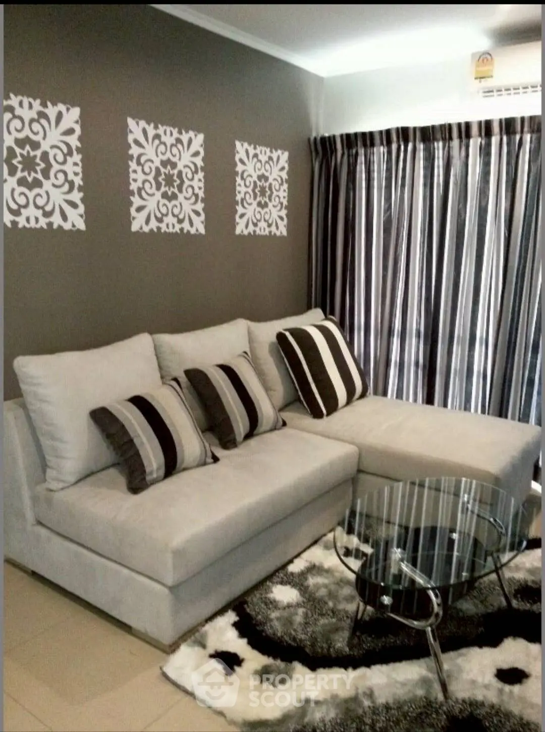 Stylish living room with modern sofa, glass coffee table, and elegant decor.