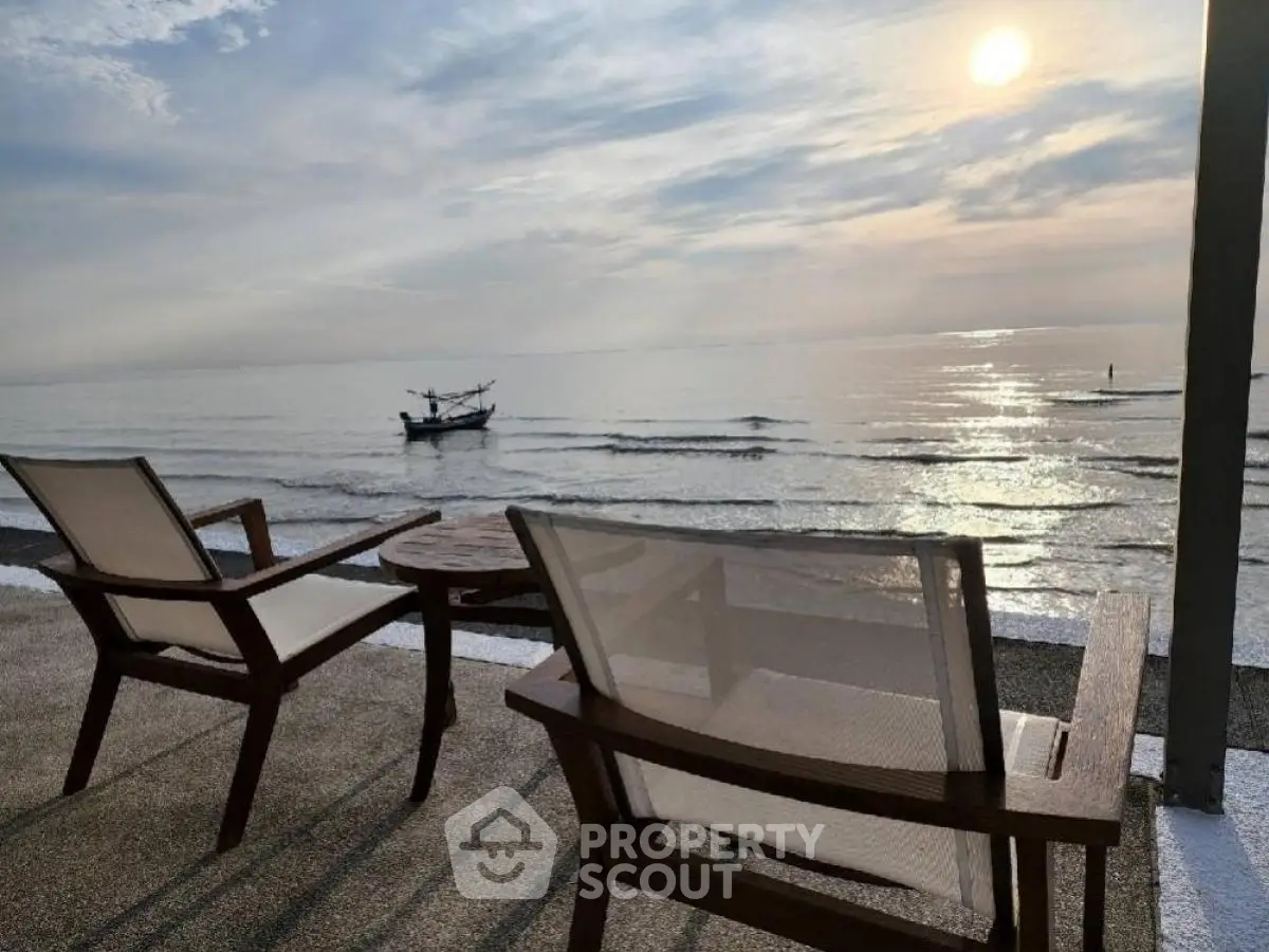 Stunning beachfront view with elegant outdoor seating at sunset